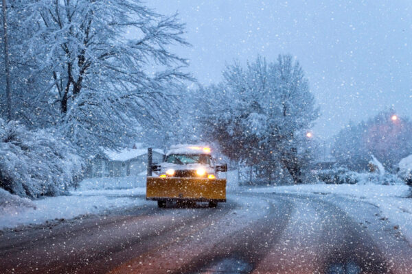 Spartan salt truck applying de-icing material during a snowfall