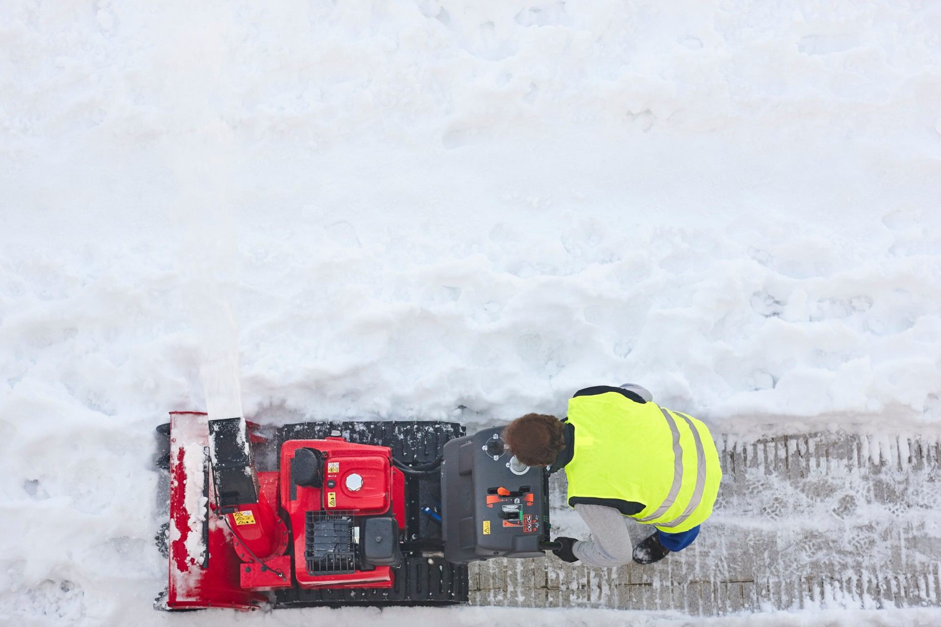 Spartan Snow Removal operator working during a winter storm