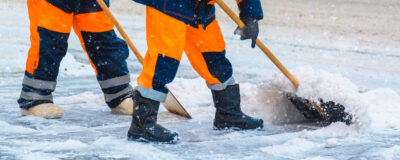 Spartan crew clearing and treating pedestrian walkways at a commercial property